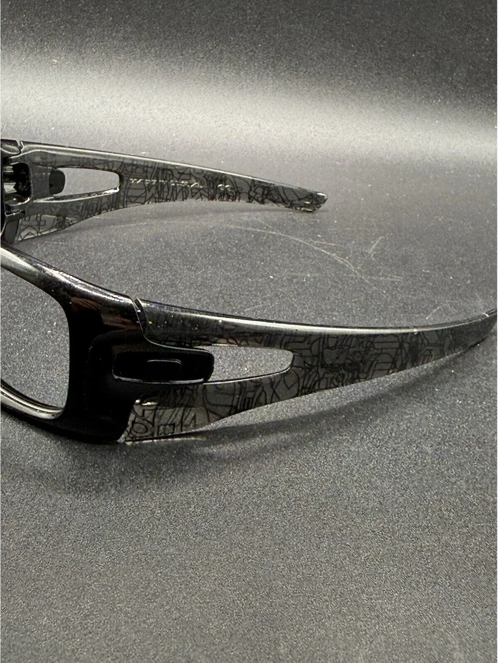 Oakley Crankcase Polished Black/Dark Grey History Text Frame (No Icons)